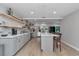 Bright, open kitchen showcasing a central island, gray cabinets, modern appliances, and ample counter space at 12677 Se 53Rd Terrace Rd, Belleview, FL 34420