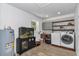 A well-equipped laundry room features modern appliances, custom shelving, and cabinet space at 12677 Se 53Rd Terrace Rd, Belleview, FL 34420