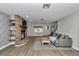 Comfortable living room with brick fireplace, plush sofa, and wood floors, bathed in natural light at 12677 Se 53Rd Terrace Rd, Belleview, FL 34420
