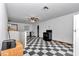 Open-concept living room with checkered flooring and kitchen at 12677 Se 53Rd Terrace Rd, Belleview, FL 34420