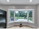 A bay window provides expansive backyard view from this cozy living room at 12677 Se 53Rd Terrace Rd, Belleview, FL 34420