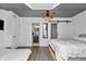 Spacious main bedroom with modern ceiling fan, barn door, and ensuite bathroom at 12677 Se 53Rd Terrace Rd, Belleview, FL 34420