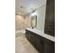 Bathroom showcasing a granite countertop vanity, dark wood cabinets, and a shower-tub combination at 13319 Sw 106Th Pl, Dunnellon, FL 34432