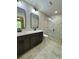 Modern bathroom featuring a double vanity, granite countertops, and a spacious glass-enclosed shower at 13319 Sw 106Th Pl, Dunnellon, FL 34432