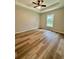 Bright bedroom featuring wood-look flooring and a ceiling fan, offering a comfortable retreat at 13319 Sw 106Th Pl, Dunnellon, FL 34432
