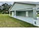 View of the large covered parking area, with side door access to the home at 13319 Sw 106Th Pl, Dunnellon, FL 34432