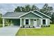 Charming single-story home with a well-maintained lawn and covered carport, showcasing curb appeal at 13319 Sw 106Th Pl, Dunnellon, FL 34432