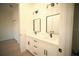 Bathroom featuring double sinks with modern black fixtures and white cabinets at 15215 Sw 43Rd Ct, Ocala, FL 34473