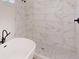 Close-up of a stylish, tiled shower featuring modern plumbing fixture and glass enclosure next to a freestanding tub at 15215 Sw 43Rd Ct, Ocala, FL 34473