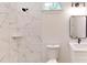 A bright and modern bathroom featuring a shower, white tiles, and a vanity with sink at 15215 Sw 43Rd Ct, Ocala, FL 34473