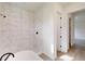 Modern bathroom featuring stylish shower with tiled wall, adjacent to a toilet space and a bright hallway at 15215 Sw 43Rd Ct, Ocala, FL 34473