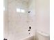 Modern bathroom showcasing elegant tile work, a bathtub, and sleek fixtures, perfect for relaxation at 15215 Sw 43Rd Ct, Ocala, FL 34473
