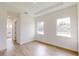 Bright bedroom with hardwood floors, recessed lighting, and natural light streaming through two windows at 15215 Sw 43Rd Ct, Ocala, FL 34473