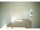 Bright bedroom with tray ceiling, light wood floors, and a window offering natural light at 15215 Sw 43Rd Ct, Ocala, FL 34473