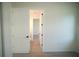 Hallway showcasing modern doors and hardware, leading to bright rooms with light wood floors at 15215 Sw 43Rd Ct, Ocala, FL 34473