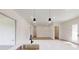 Open-concept kitchen island, stainless steel sink, and modern lighting fixtures at 15215 Sw 43Rd Ct, Ocala, FL 34473
