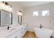 Spacious main bathroom featuring double sinks, modern fixtures, a soaking tub, and a separate shower at 15215 Sw 43Rd Ct, Ocala, FL 34473