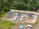 Expansive aerial view of the property showing the pool, outdoor seating, and surrounding landscape at 15324 Sw 40Th Place Rd, Ocala, FL 34481