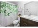 Bathroom features a sink with vanity, mirror, and a decorative shower curtain at 15324 Sw 40Th Place Rd, Ocala, FL 34481