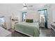 Bright bedroom features a large headboard, a chandelier fan, and natural light at 15324 Sw 40Th Place Rd, Ocala, FL 34481