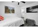 Cozy bedroom with decorative painting, ceiling fan, and a television mounted on the wall at 15324 Sw 40Th Place Rd, Ocala, FL 34481
