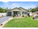 Charming single-story home with a well-manicured lawn and decorative landscaping at 15324 Sw 40Th Place Rd, Ocala, FL 34481