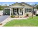 Inviting single-story home featuring a cozy front porch and beautifully landscaped yard at 15324 Sw 40Th Place Rd, Ocala, FL 34481