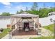 Relax in this cozy gazebo complete with rocking chairs, string lights, and potted plants at 15324 Sw 40Th Place Rd, Ocala, FL 34481