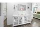 Hallway showcasing decorative wall accents and a white storage console with mirrored doors at 15324 Sw 40Th Place Rd, Ocala, FL 34481