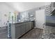 Kitchen island bar with granite countertops and stainless steel dishwasher at 15324 Sw 40Th Place Rd, Ocala, FL 34481
