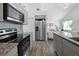 Open kitchen view with stainless steel refrigerator and appliances, flowing into the living area at 15324 Sw 40Th Place Rd, Ocala, FL 34481