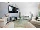 Living room featuring vaulted ceilings, modern decor, and large screen TV at 15324 Sw 40Th Place Rd, Ocala, FL 34481