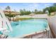 Above ground pool in fenced backyard with slide, pool lights, and surrounding patio at 15324 Sw 40Th Place Rd, Ocala, FL 34481