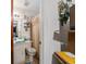 Small bathroom with a toilet, shelves, and shower curtain at 17128 Se 140Th Ave, Weirsdale, FL 32195