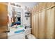 Small bathroom with a sink, toilet, shower curtain, and accessories at 17128 Se 140Th Ave, Weirsdale, FL 32195