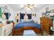 Comfortable bedroom with a bed, ceiling fan, and a wooden bed frame at 17128 Se 140Th Ave, Weirsdale, FL 32195