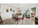 Bright dining room with a modern chandelier and a sliding glass door at 17128 Se 140Th Ave, Weirsdale, FL 32195