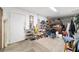 Spacious garage with storage shelving and a variety of tools and household items at 17128 Se 140Th Ave, Weirsdale, FL 32195