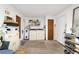 A functional laundry room featuring a washer, dryer, and additional storage shelving at 17128 Se 140Th Ave, Weirsdale, FL 32195