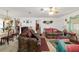 Open-concept living room with patterned sofas and a dining area at 17128 Se 140Th Ave, Weirsdale, FL 32195