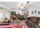 Cozy living room with comfortable seating, a ceiling fan, and natural lighting at 17128 Se 140Th Ave, Weirsdale, FL 32195