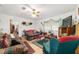 Cozy living room featuring a ceiling fan and comfortable, patterned furniture at 17128 Se 140Th Ave, Weirsdale, FL 32195