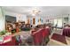 Open living room featuring a ceiling fan, television and seamless access to the dining area at 17128 Se 140Th Ave, Weirsdale, FL 32195