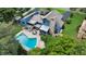 Aerial view of a blue house showcasing the pool, patio, and well-maintained backyard at 2922 Cocovia Way, Leesburg, FL 34748