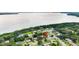 Beautiful aerial view of the home highlighting a pool, mature trees, and a waterfront neighborhood at 2922 Cocovia Way, Leesburg, FL 34748