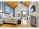 Bright bedroom with vaulted ceiling, wooden floors, and elegant decor at 2922 Cocovia Way, Leesburg, FL 34748