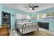 Cozy bedroom with sea-inspired decor, ceiling fan, and ample natural light at 2922 Cocovia Way, Leesburg, FL 34748