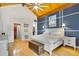 Spacious bedroom with vaulted ceiling, ensuite bath, and natural wood floors at 2922 Cocovia Way, Leesburg, FL 34748