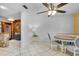 Bright dining area with round table, three chairs, and a ceiling fan at 2922 Cocovia Way, Leesburg, FL 34748