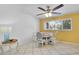 Sunny dining area with tiled floor, ceiling fan, and built-in banquette seating at 2922 Cocovia Way, Leesburg, FL 34748